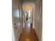 Hallway with wood floors and closet space, leading to a bright room, perfect for storage at 976 Dancing Vines Ave, Las Vegas, NV 89183