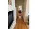 Hallway with wood floors leading to a bedroom, offering a glimpse of a cozy interior at 976 Dancing Vines Ave, Las Vegas, NV 89183