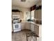 Cozy kitchen featuring tile flooring, wooden cabinets, a white dishwasher and matching white oven at 976 Dancing Vines Ave, Las Vegas, NV 89183