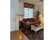 Cozy living room featuring a floral valance, plush sofa and a vintage white coffee table at 976 Dancing Vines Ave, Las Vegas, NV 89183
