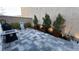 Stylish backyard with paver patio, potted trees, and a modern water feature, perfect for outdoor entertaining at 1027 Brilliant Meadow Ave, North Las Vegas, NV 89086