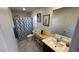 Full bathroom featuring a vanity, a shower and tub, plus a mirror at 1027 Brilliant Meadow Ave, North Las Vegas, NV 89086