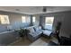 Bright living room with a comfortable gray couch and multiple windows at 1027 Brilliant Meadow Ave, North Las Vegas, NV 89086