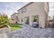 Private backyard featuring a paver patio, low maintenance turf, and desert landscaping at 10376 Sadie Blake Ave, Las Vegas, NV 89166
