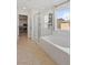 Bright bathroom featuring a glass enclosed shower and soaker tub at 10376 Sadie Blake Ave, Las Vegas, NV 89166