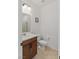 Cozy bathroom featuring a wood vanity with a white countertop and a toilet at 10376 Sadie Blake Ave, Las Vegas, NV 89166