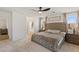 Bright bedroom featuring a tufted headboard, soft carpet, and natural light at 10376 Sadie Blake Ave, Las Vegas, NV 89166