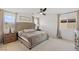 Bright bedroom featuring a tufted headboard, soft carpet, and natural light at 10376 Sadie Blake Ave, Las Vegas, NV 89166