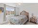 Inviting bedroom with a large window, comfy bed, and decorative accents at 10376 Sadie Blake Ave, Las Vegas, NV 89166