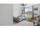 bedroom with a ceiling fan and window and toys at 10376 Sadie Blake Ave, Las Vegas, NV 89166