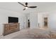 Bedroom featuring a mounted TV and doors to the bathroom and closet at 10376 Sadie Blake Ave, Las Vegas, NV 89166