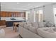 Open-concept kitchen with stainless steel appliances, a kitchen island, and a seamless flow to the living area at 10376 Sadie Blake Ave, Las Vegas, NV 89166