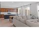 Open-concept kitchen with stainless steel appliances, a kitchen island, and a seamless flow to the living area at 10376 Sadie Blake Ave, Las Vegas, NV 89166
