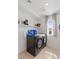 Modern laundry room with tile floors, a new washer and dryer, and natural light at 10376 Sadie Blake Ave, Las Vegas, NV 89166