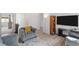 Open-concept living room with wood-look floors, comfortable seating, and neutral decor at 10376 Sadie Blake Ave, Las Vegas, NV 89166