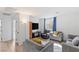 Bright living room with modern furniture, wood-look floors, and natural light at 10376 Sadie Blake Ave, Las Vegas, NV 89166
