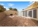 Backyard with desert landscaping, including rock ground cover and a small patio area near the house at 10505 Linden Wood Ct, Las Vegas, NV 89134