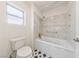 Cozy bathroom showcasing a tub with shower and decorative tiles, including black and white floor at 10505 Linden Wood Ct, Las Vegas, NV 89134