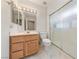 Bright bathroom featuring a single sink vanity, toilet, and a glass-enclosed shower at 10505 Linden Wood Ct, Las Vegas, NV 89134