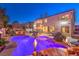 An expansive backyard features a private pool, spa, patio, outdoor kitchen, and plenty of space to relax and entertain at 11072 Pentland Downs St, Las Vegas, NV 89141