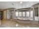 Elegant bathroom with a large soaking tub, glass shower, and natural light streaming through the expansive windows at 11072 Pentland Downs St, Las Vegas, NV 89141