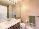 Bathroom with a marble countertop vanity, modern faucet, and framed mirror at 11072 Pentland Downs St, Las Vegas, NV 89141