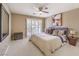 Well-lit bedroom with a ceiling fan, window with shutters, and comfortable decor at 11072 Pentland Downs St, Las Vegas, NV 89141