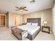 Inviting bedroom featuring a ceiling fan, neutral palette, and a bench seat at 11072 Pentland Downs St, Las Vegas, NV 89141