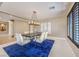 Open-concept dining room with modern lighting and a decorative area rug at 11072 Pentland Downs St, Las Vegas, NV 89141