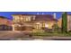 Stunning two-story stone home featuring a three-car garage and meticulous landscaping at 11072 Pentland Downs St, Las Vegas, NV 89141