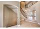 Grand foyer showcasing a staircase with wrought iron details and tile flooring at 11072 Pentland Downs St, Las Vegas, NV 89141