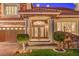 Elegant home entrance with stone facade, pillars, and decorative double doors at 11072 Pentland Downs St, Las Vegas, NV 89141