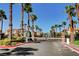 A gated community entrance with palm trees and well-maintained landscaping for added security and curb appeal at 11072 Pentland Downs St, Las Vegas, NV 89141