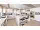 Spacious kitchen with stainless steel appliances, an island with seating, and white cabinetry at 11072 Pentland Downs St, Las Vegas, NV 89141