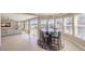 Bright living room area with ample natural light and an adjacent dining space with a modern table set at 11072 Pentland Downs St, Las Vegas, NV 89141