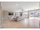 Open-concept living room featuring a sectional sofa, tile floors, and a view of the backyard pool at 11072 Pentland Downs St, Las Vegas, NV 89141