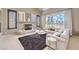 Comfortable living room with a fireplace, plush seating, and large windows at 11072 Pentland Downs St, Las Vegas, NV 89141