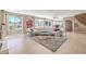 Spacious living room with large windows, tile flooring, and a view of the pool at 11072 Pentland Downs St, Las Vegas, NV 89141