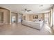 Bright and airy living room with a large sectional sofa, tile flooring, and a modern bar area at 11072 Pentland Downs St, Las Vegas, NV 89141