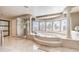 Bright and open main bathroom featuring a soaking tub and large glass shower at 11072 Pentland Downs St, Las Vegas, NV 89141