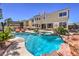 Gorgeous backyard pool with a baja shelf, spa, and lush landscaping at 11072 Pentland Downs St, Las Vegas, NV 89141