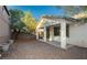 Spacious backyard with a covered patio and low-maintenance gravel landscaping at 11204 Newbury Hills Ave, Las Vegas, NV 89138