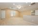 Spacious bonus room with neutral carpet, a ceiling fan, and two large windows at 11204 Newbury Hills Ave, Las Vegas, NV 89138