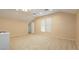 Large bonus room with neutral carpet, a ceiling fan, and a staircase entrance at 11204 Newbury Hills Ave, Las Vegas, NV 89138