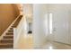 Inviting foyer with a staircase, light tile flooring, and a front door with decorative glass at 11204 Newbury Hills Ave, Las Vegas, NV 89138