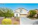 Inviting two-story home featuring a well-manicured lawn and a two car garage at 11204 Newbury Hills Ave, Las Vegas, NV 89138