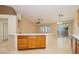 Open-concept kitchen island featuring wooden cabinets and white countertop, seamlessly connected to the dining area at 11204 Newbury Hills Ave, Las Vegas, NV 89138