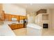 Bright kitchen with white countertops, wooden cabinets and a central island for extra workspace at 11204 Newbury Hills Ave, Las Vegas, NV 89138