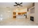 Open concept living space with fireplace, kitchen and dining area with natural light at 11204 Newbury Hills Ave, Las Vegas, NV 89138