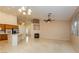 Spacious living room with views of the kitchen, fireplace, and ceiling fan at 11204 Newbury Hills Ave, Las Vegas, NV 89138